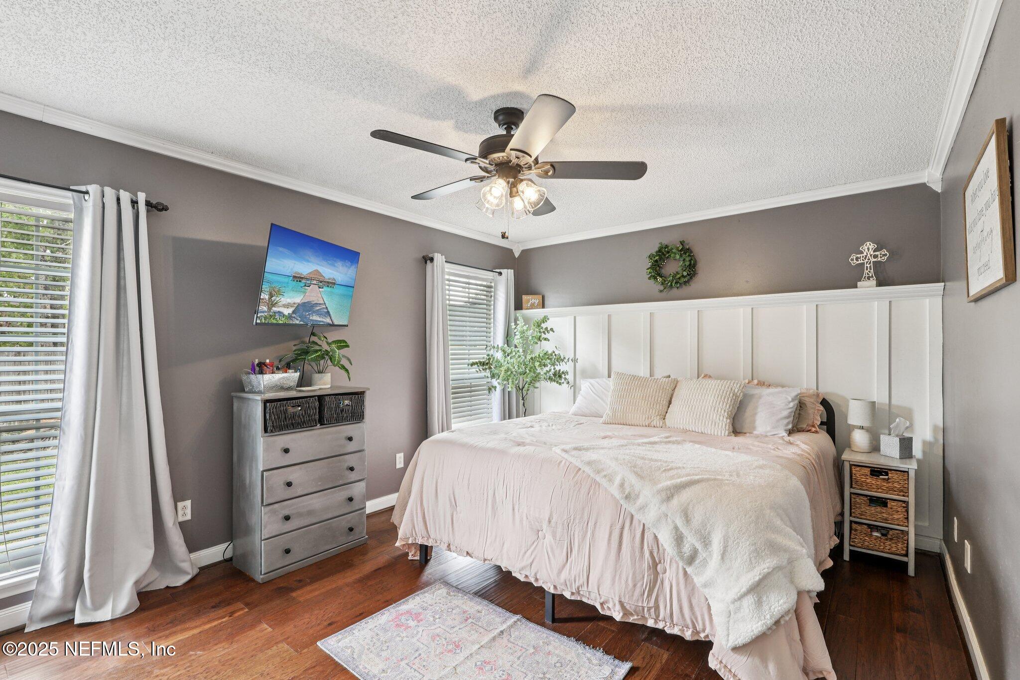 8053 Queensferry Lane Jacksonville, FL 32244 - Photo 17 of 45 a bedroom with a bed and a chandelier