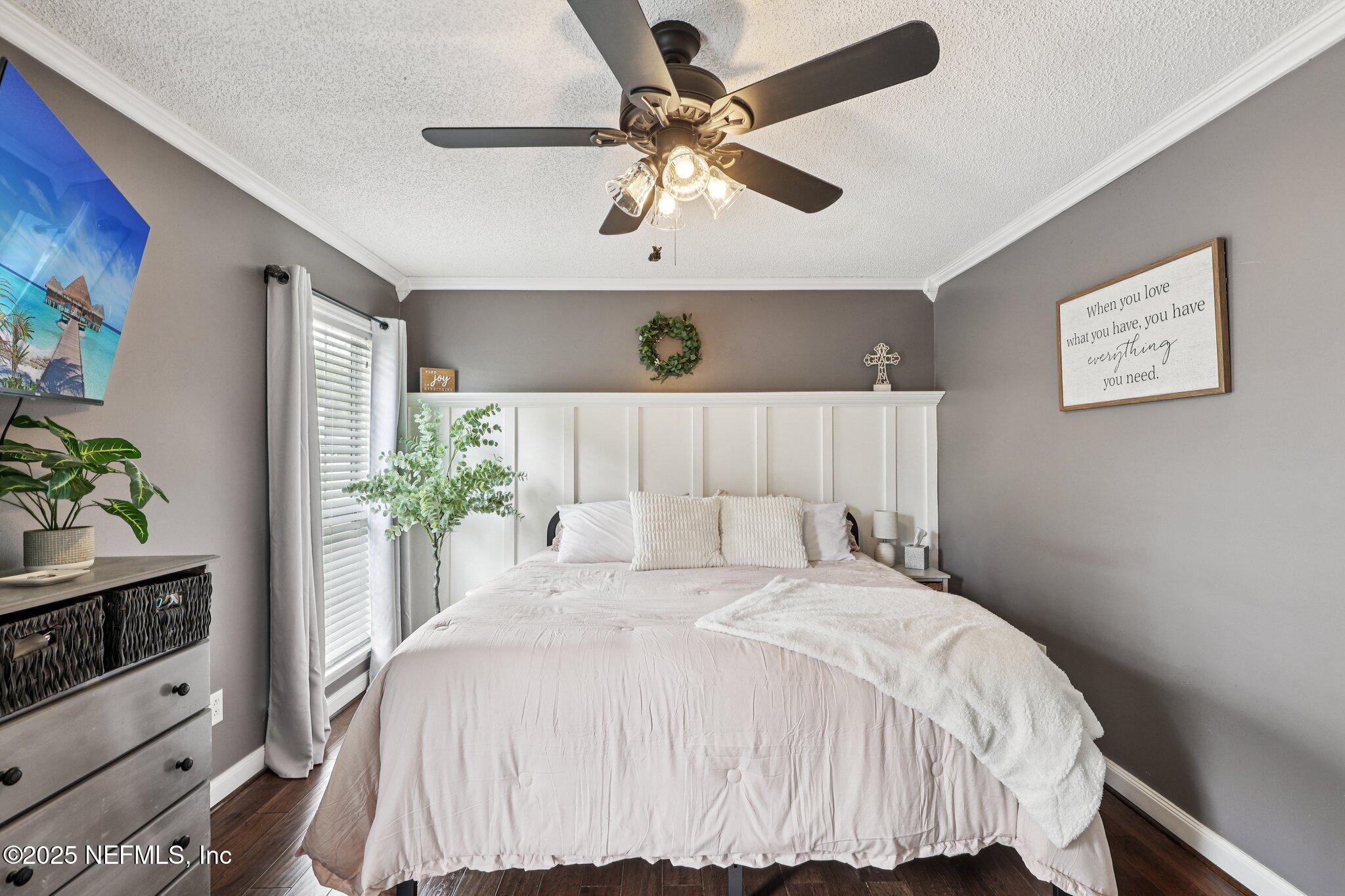 8053 Queensferry Lane Jacksonville, FL 32244 - Photo 18 of 45 a bedroom with a large bed and a chandelier