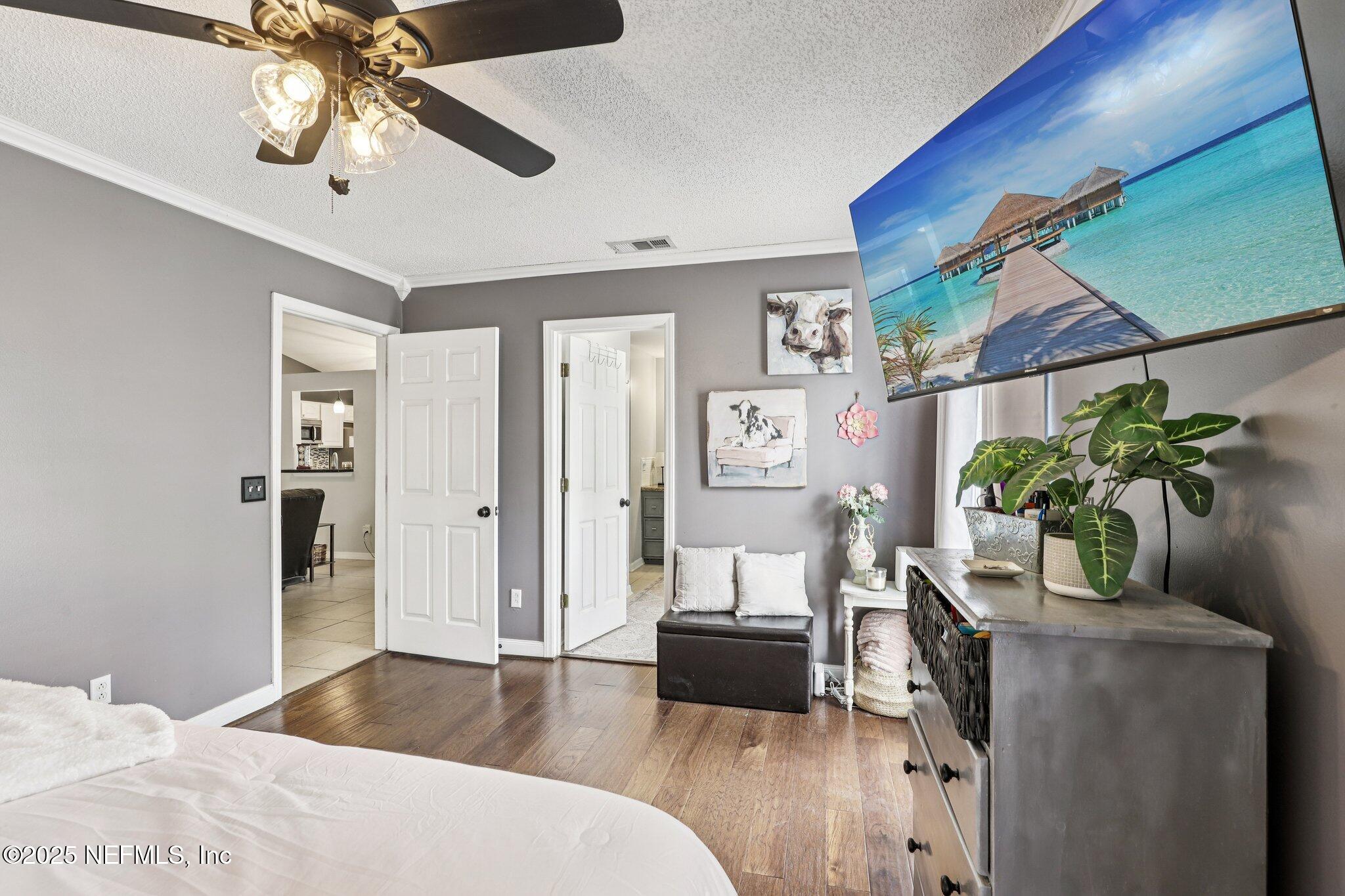 8053 Queensferry Lane Jacksonville, FL 32244 - Photo 19 of 45 a bedroom with furniture and a potted plant