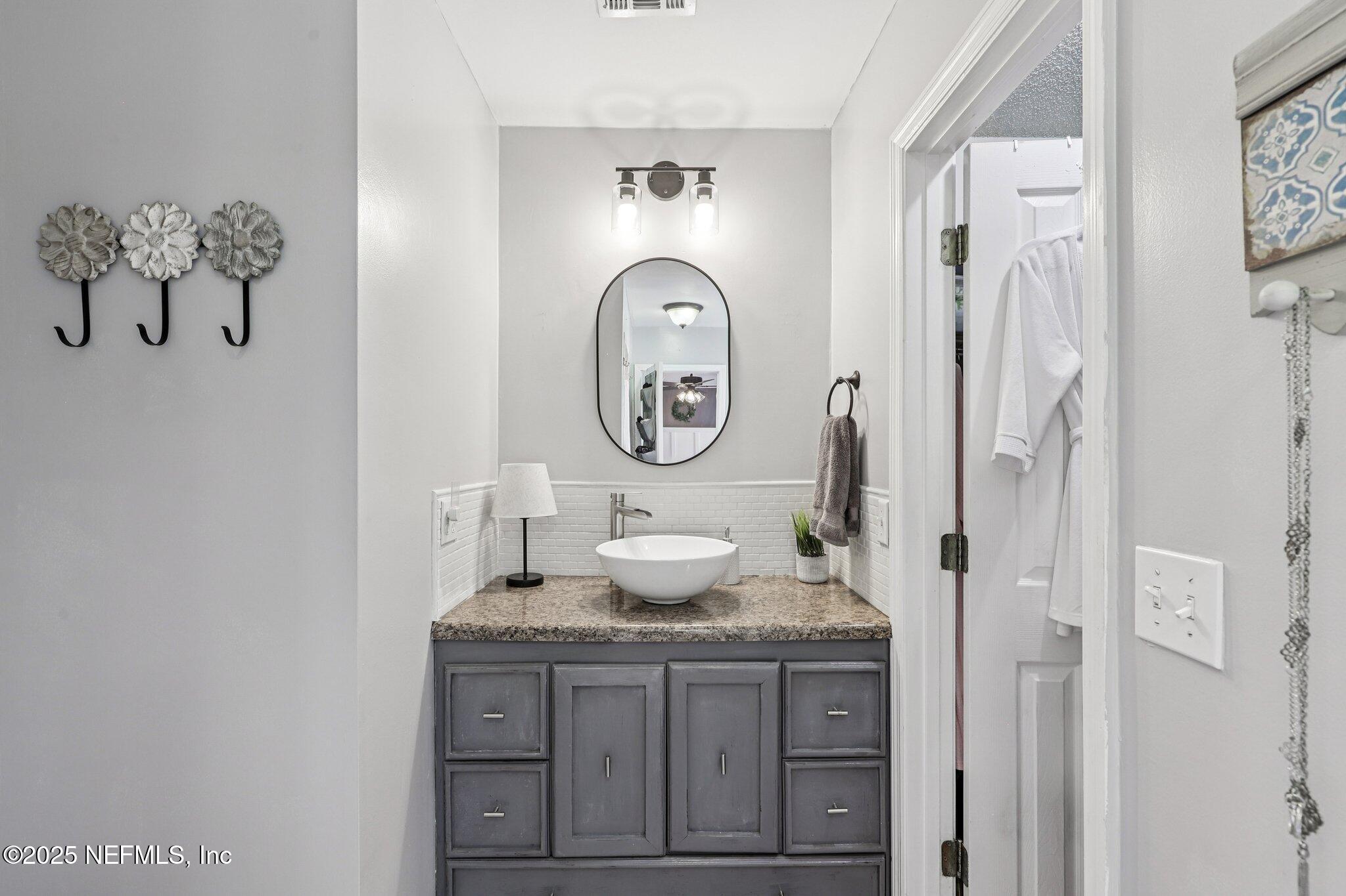 8053 Queensferry Lane Jacksonville, FL 32244 - Photo 21 of 45 a bathroom with a granite countertop sink and a mirror