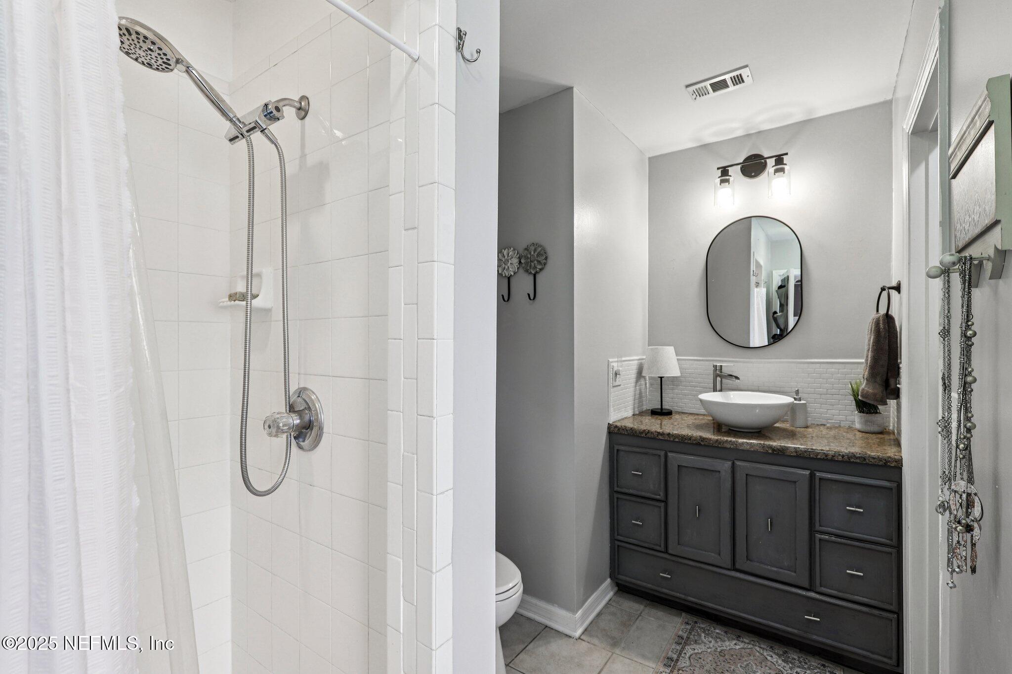 8053 Queensferry Lane Jacksonville, FL 32244 - Photo 22 of 45 a bathroom with a double vanity sink mirror and shower