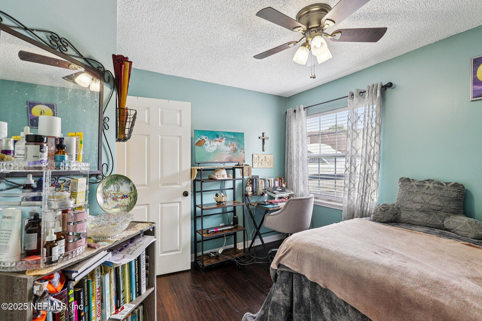 8053 Queensferry Lane Jacksonville, FL 32244 - Photo 24 of 45 a bedroom with furniture window and wooden floor