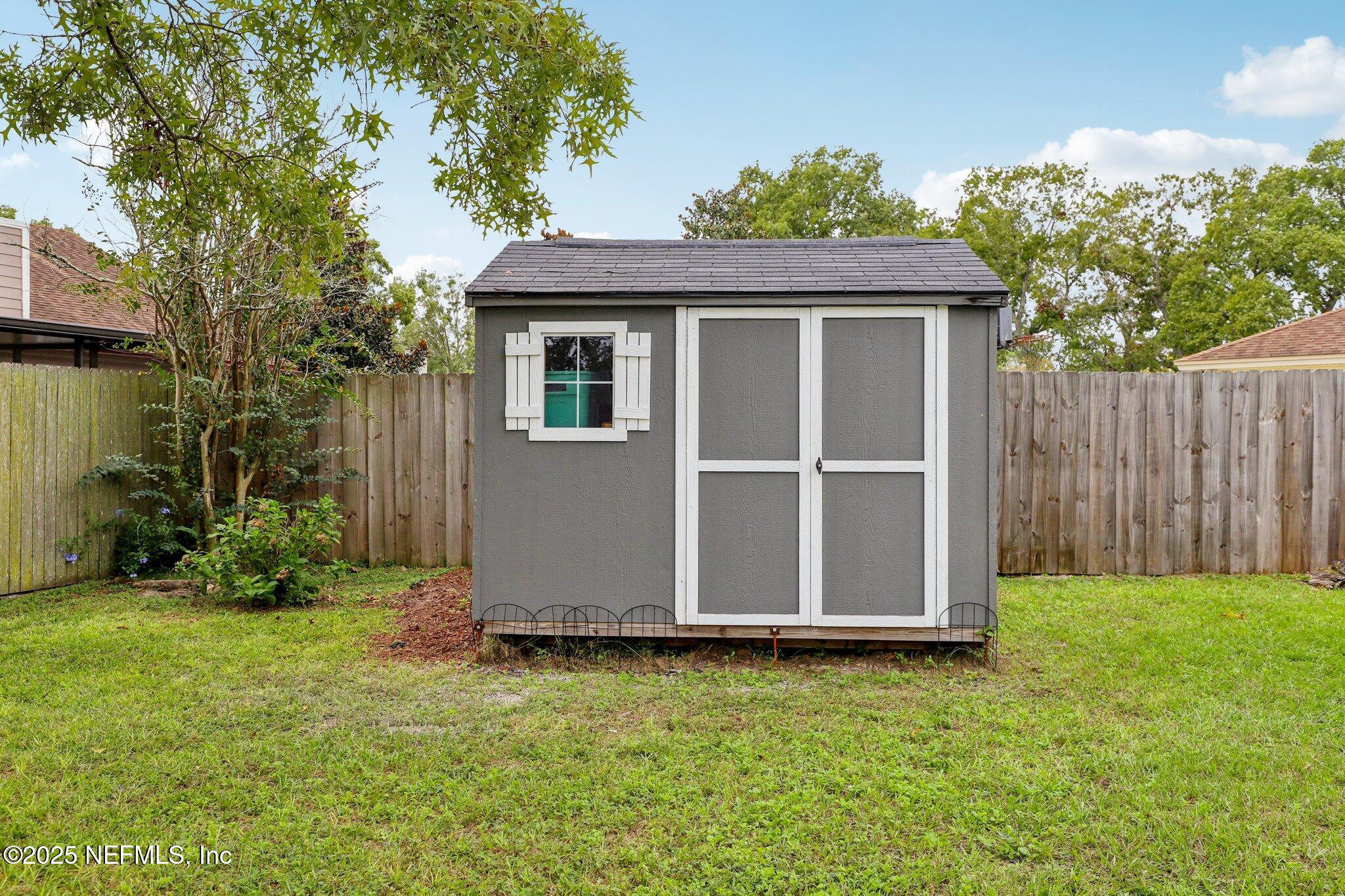 8053 Queensferry Lane Jacksonville, FL 32244 - Photo 32 of 45 a view of backyard with potted plants and a large tree