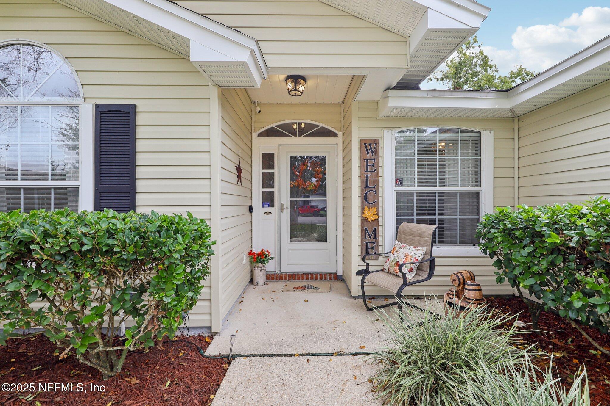 8053 Queensferry Lane Jacksonville, FL 32244 - Photo 4 of 45 a front view of a house with outdoor seating and a lots of potted plants