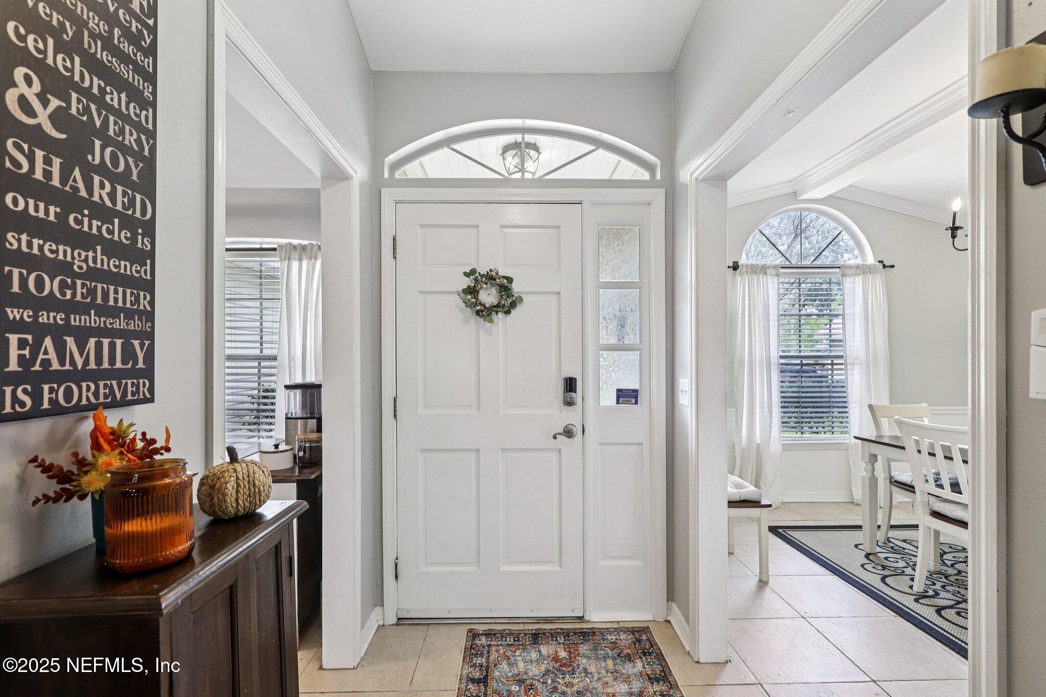 8053 Queensferry Lane Jacksonville, FL 32244 - Photo 5 of 45 a view of a hallway to a livingroom with furniture and window