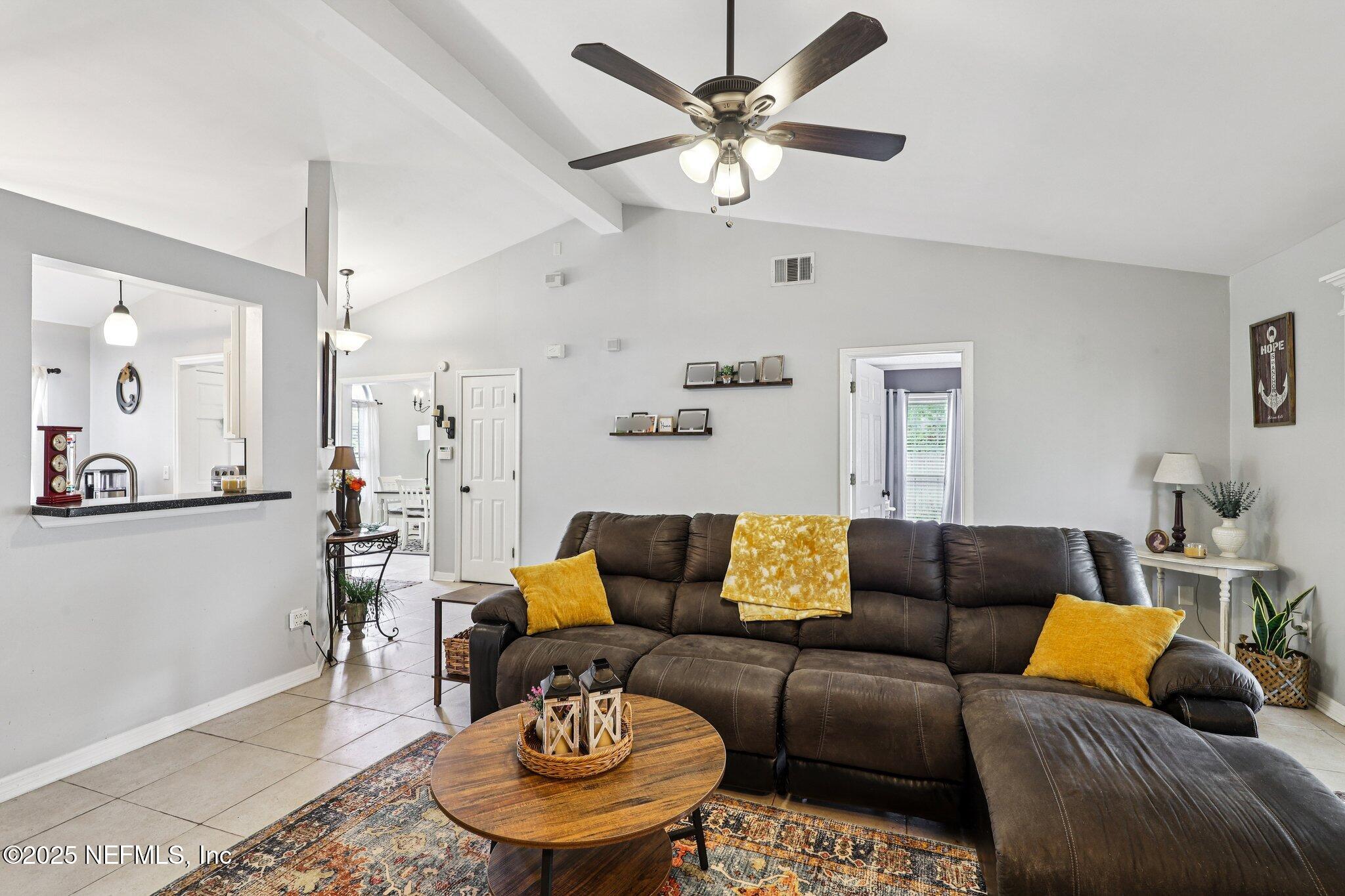 8053 Queensferry Lane Jacksonville, FL 32244 - Photo 9 of 45 a living room with furniture and a chandelier