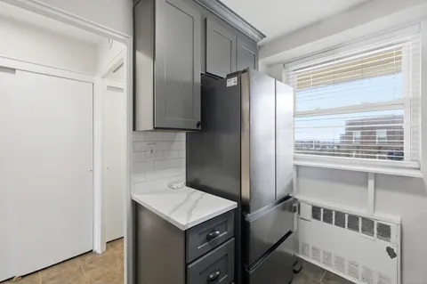 a kitchen with a refrigerator and a sink