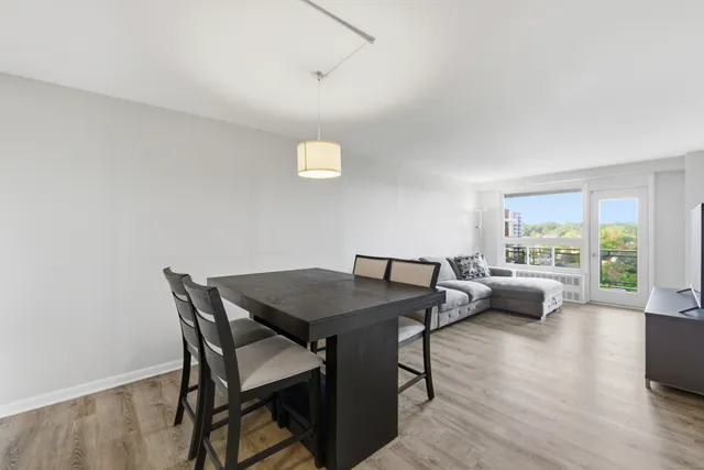 a view of a dining room with furniture and wooden floor