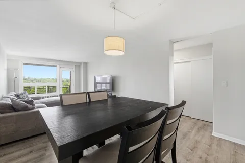 a view of a dining room with a table and chairs