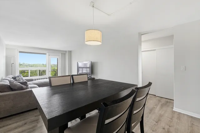 a view of a dining room with a table and chairs