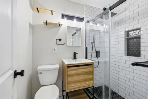 a bathroom with a toilet sink and shower
