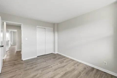 a view of an empty room and wooden floor