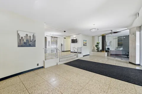 a large bedroom with a large bed and a view of bathroom