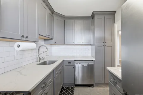 a kitchen with a sink cabinets and appliances
