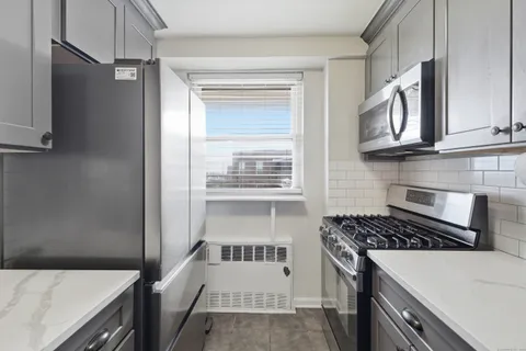 a kitchen with granite countertop a stove and a refrigerator