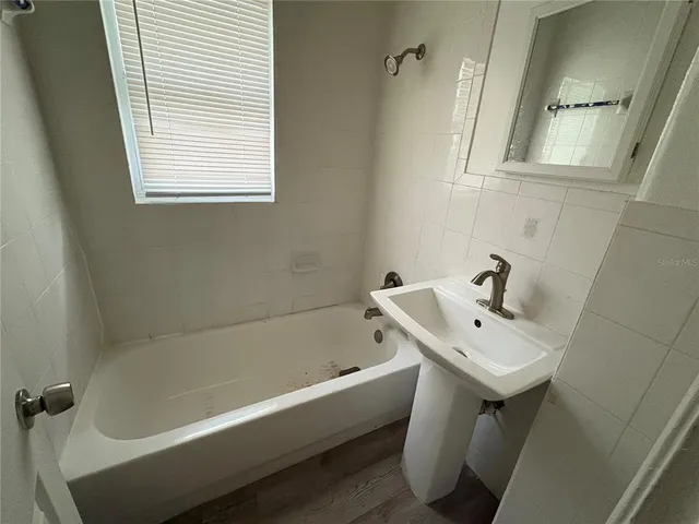 a white bath tub sitting next to a white sink