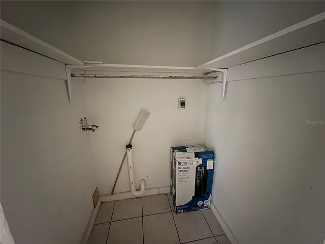 a view of storage and utility room with empty racks