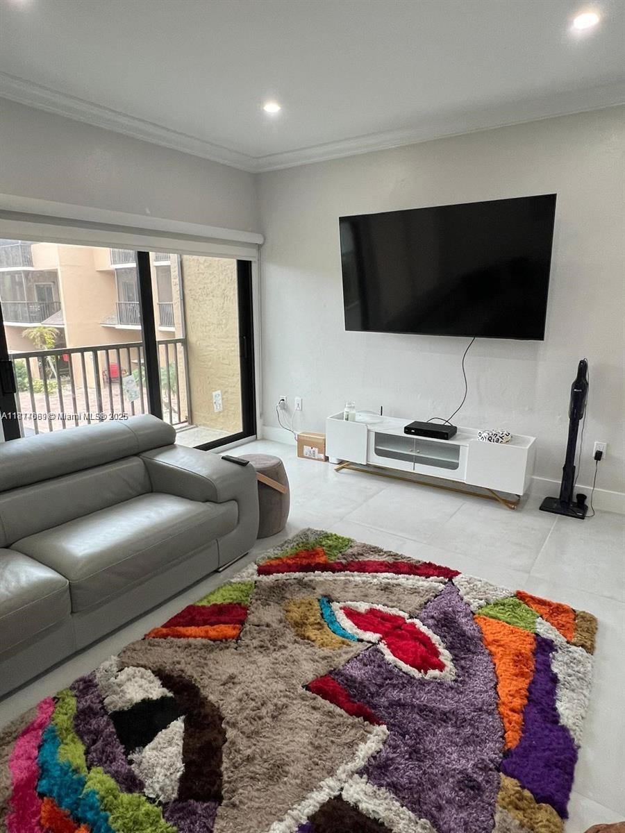 1103 South Collier Boulevard, Unit C108 Marco Island, FL 34145 - Photo 11 of 34 a living room with furniture and a flat screen tv
