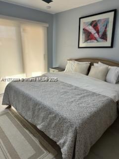 1103 South Collier Boulevard, Unit C108 Marco Island, FL 34145 - Photo 15 of 34 a large bed sitting in a bedroom next to a window