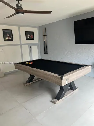 a room with gym equipment and a flat screen tv