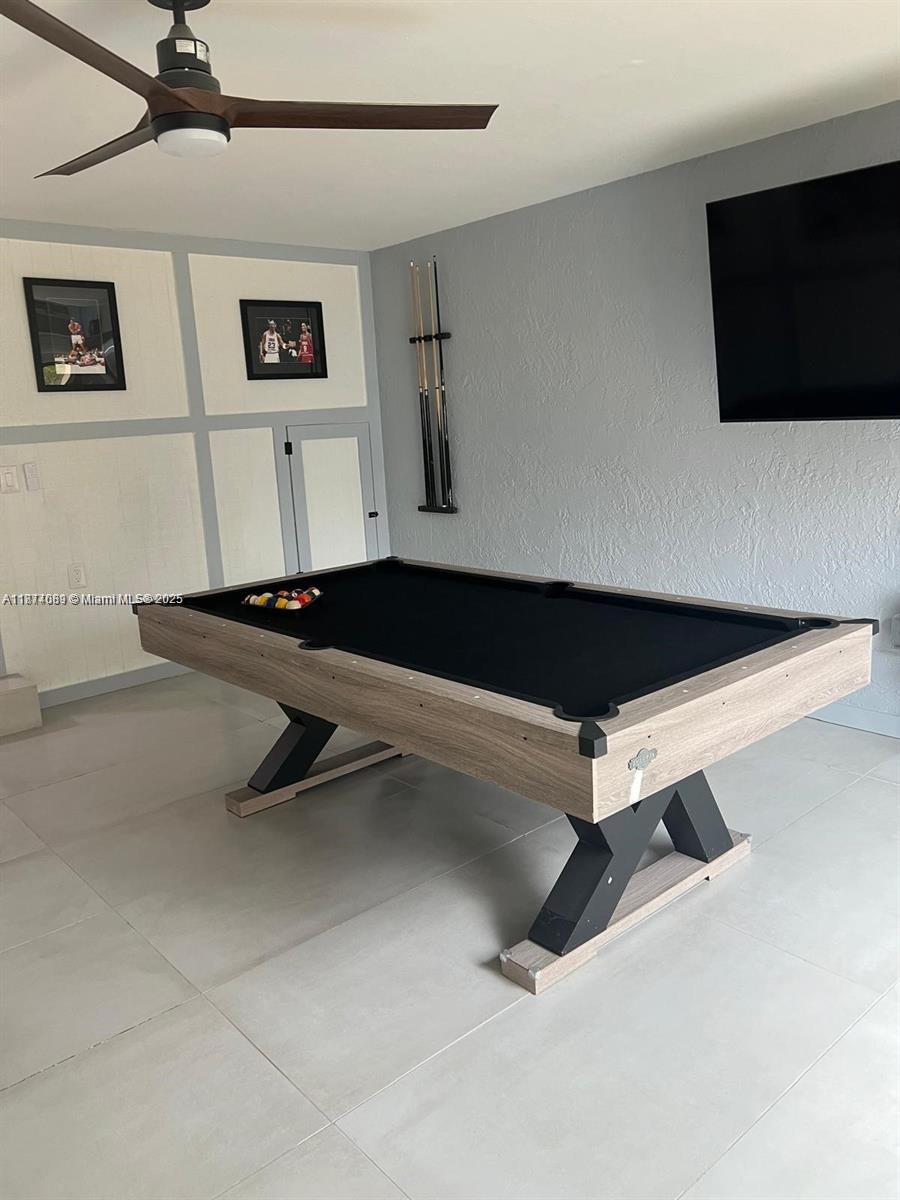 1103 South Collier Boulevard, Unit C108 Marco Island, FL 34145 - Photo 18 of 34 a room with gym equipment and a flat screen tv