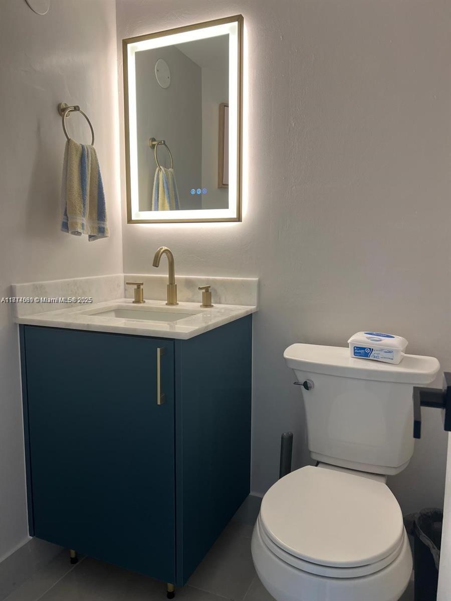 1103 South Collier Boulevard, Unit C108 Marco Island, FL 34145 - Photo 20 of 34 a white toilet sitting next to a bathroom sink