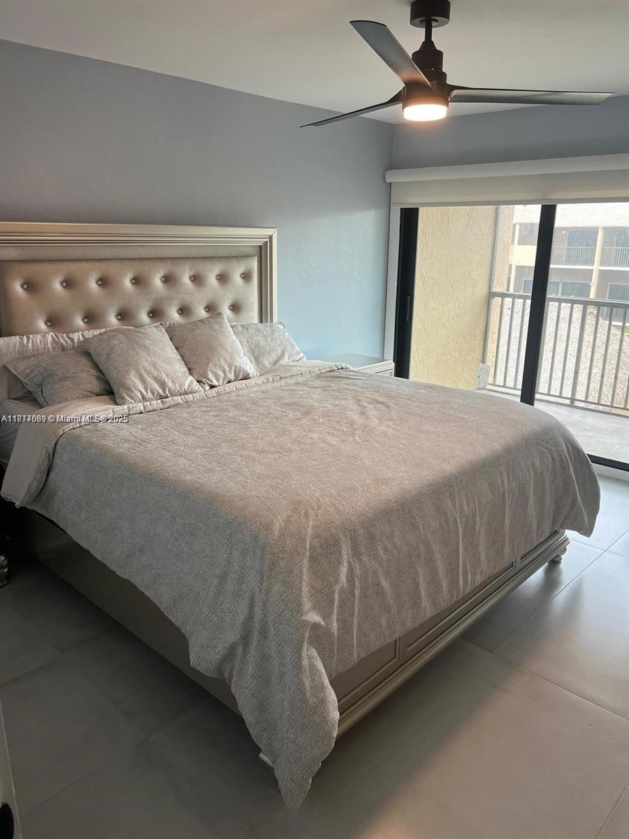 1103 South Collier Boulevard, Unit C108 Marco Island, FL 34145 - Photo 21 of 34 a large bed sitting in a bedroom next to a window