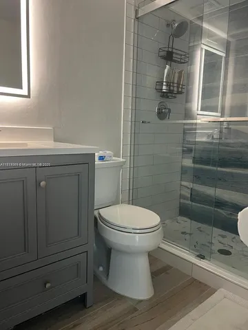 a bathroom with a toilet a sink and shower