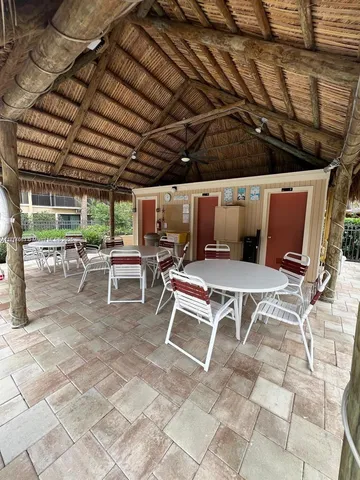 a building outdoor space with patio furniture and potted plants