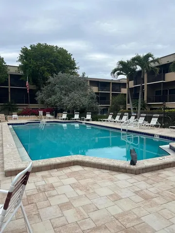 a view of a swimming pool with a yard