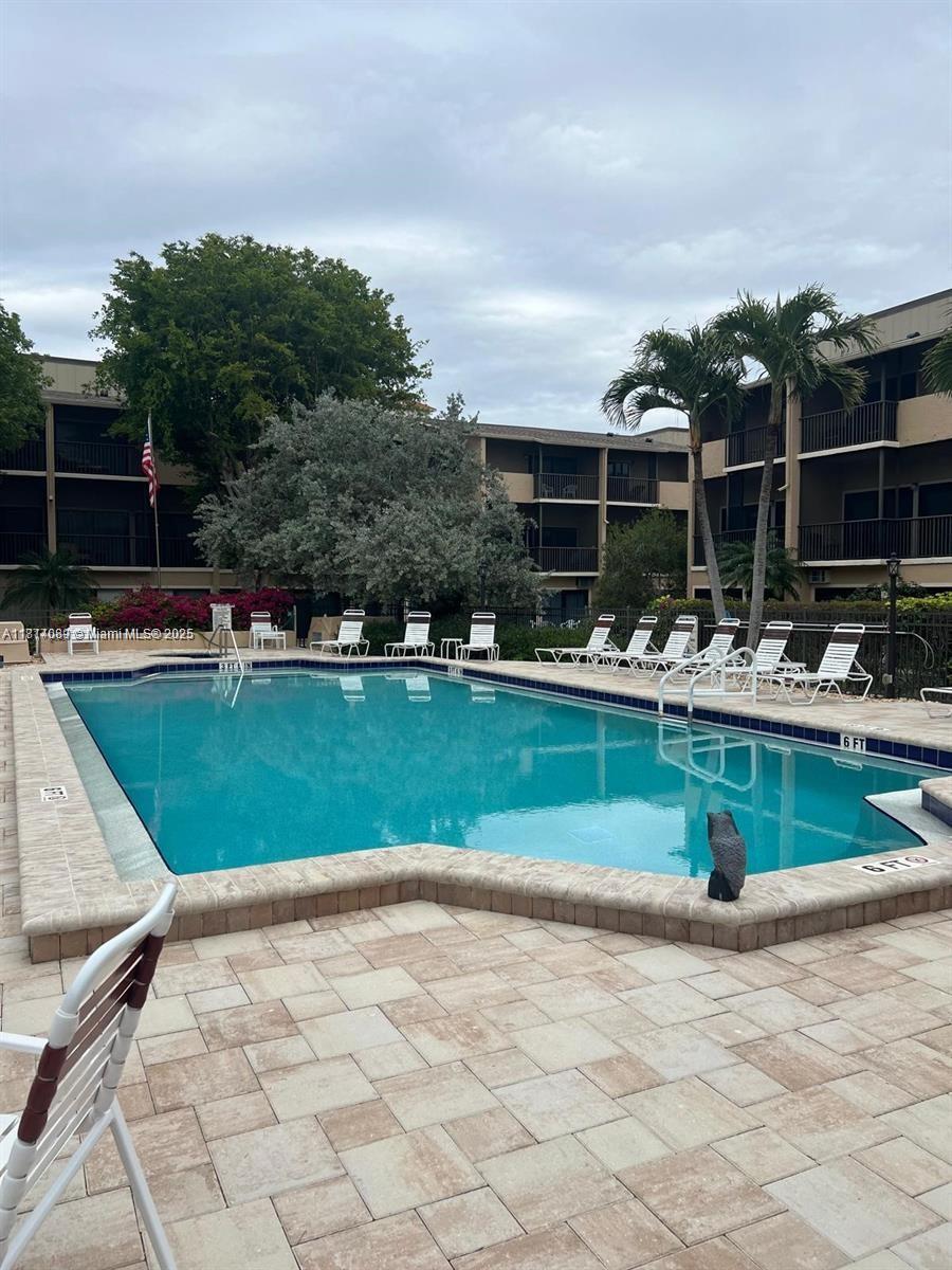 1103 South Collier Boulevard, Unit C108 Marco Island, FL 34145 - Photo 33 of 34 a view of a swimming pool with a yard
