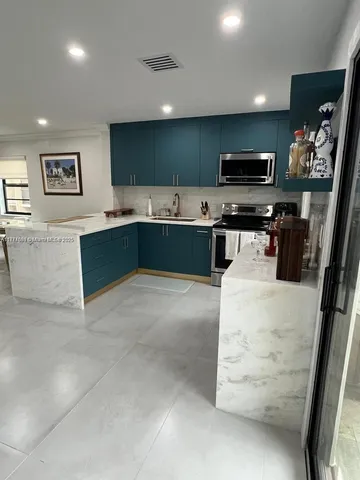 a kitchen with stainless steel appliances a microwave and a sink