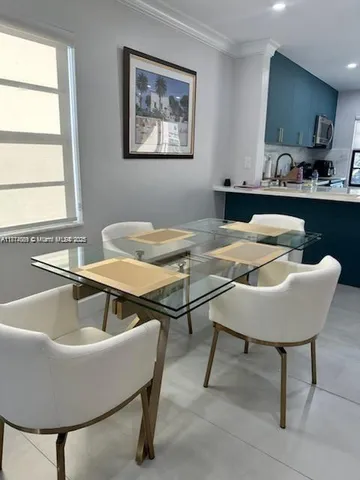a view of a dining room with furniture and window