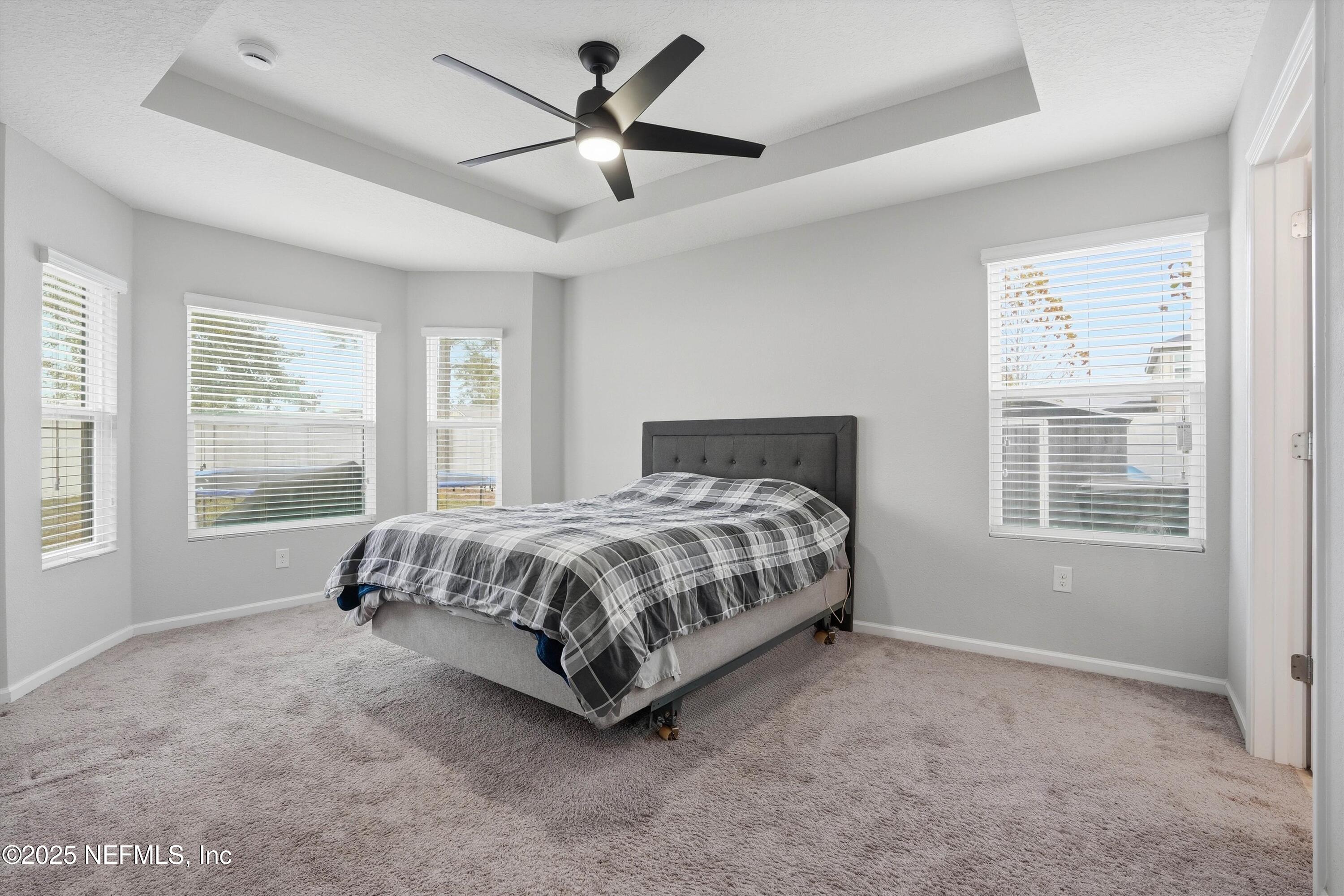 3994 Great Falls Loop Middleburg, FL 32068 - Photo 14 of 30 a spacious bedroom with a bed painting and a large window