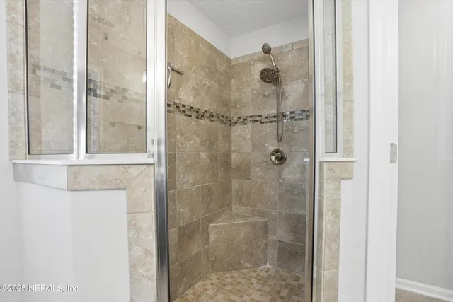a bathroom with a glass shower door