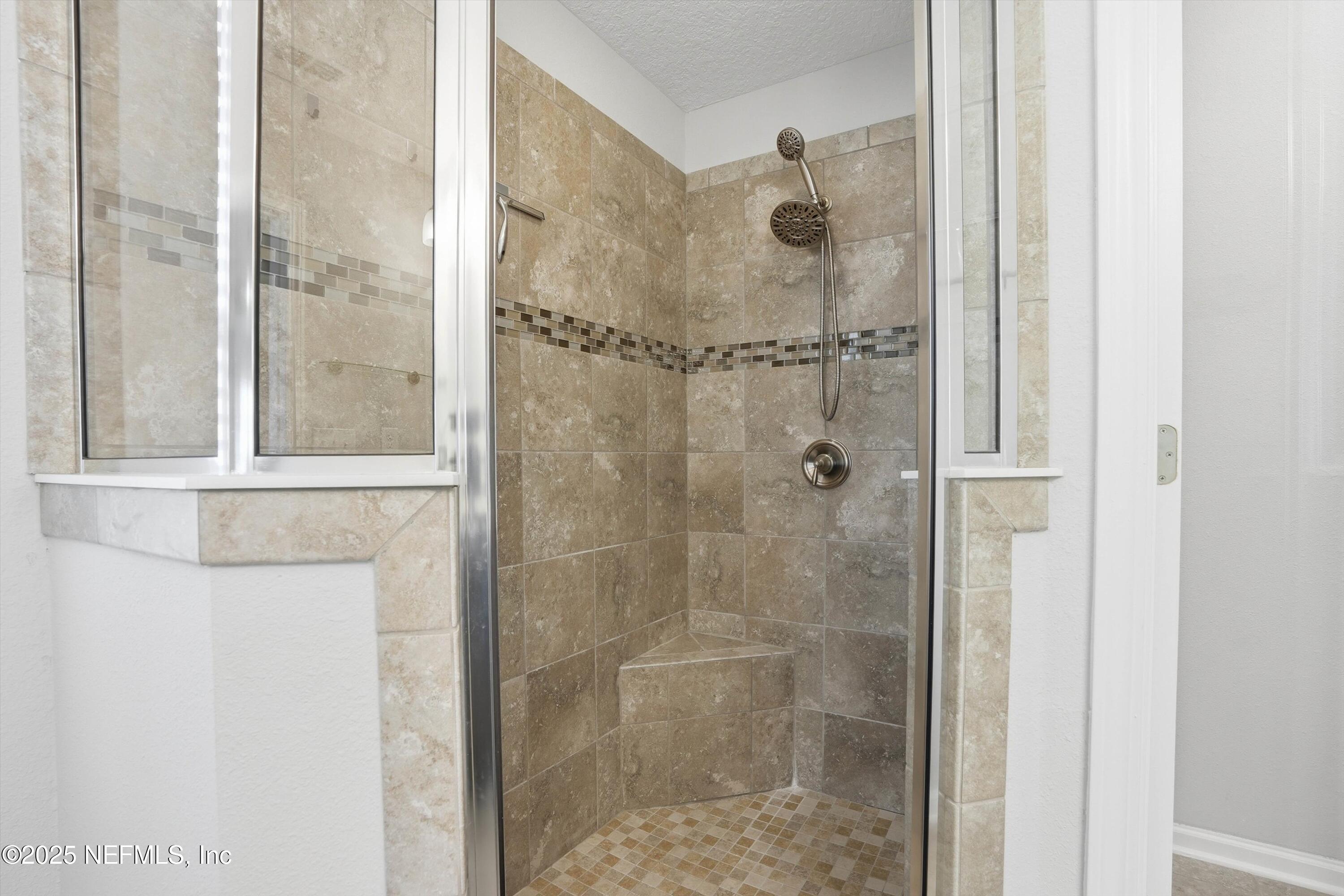 3994 Great Falls Loop Middleburg, FL 32068 - Photo 17 of 30 a bathroom with a glass shower door