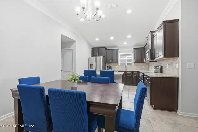 a view of kitchen with granite countertop cabinets table and chairs