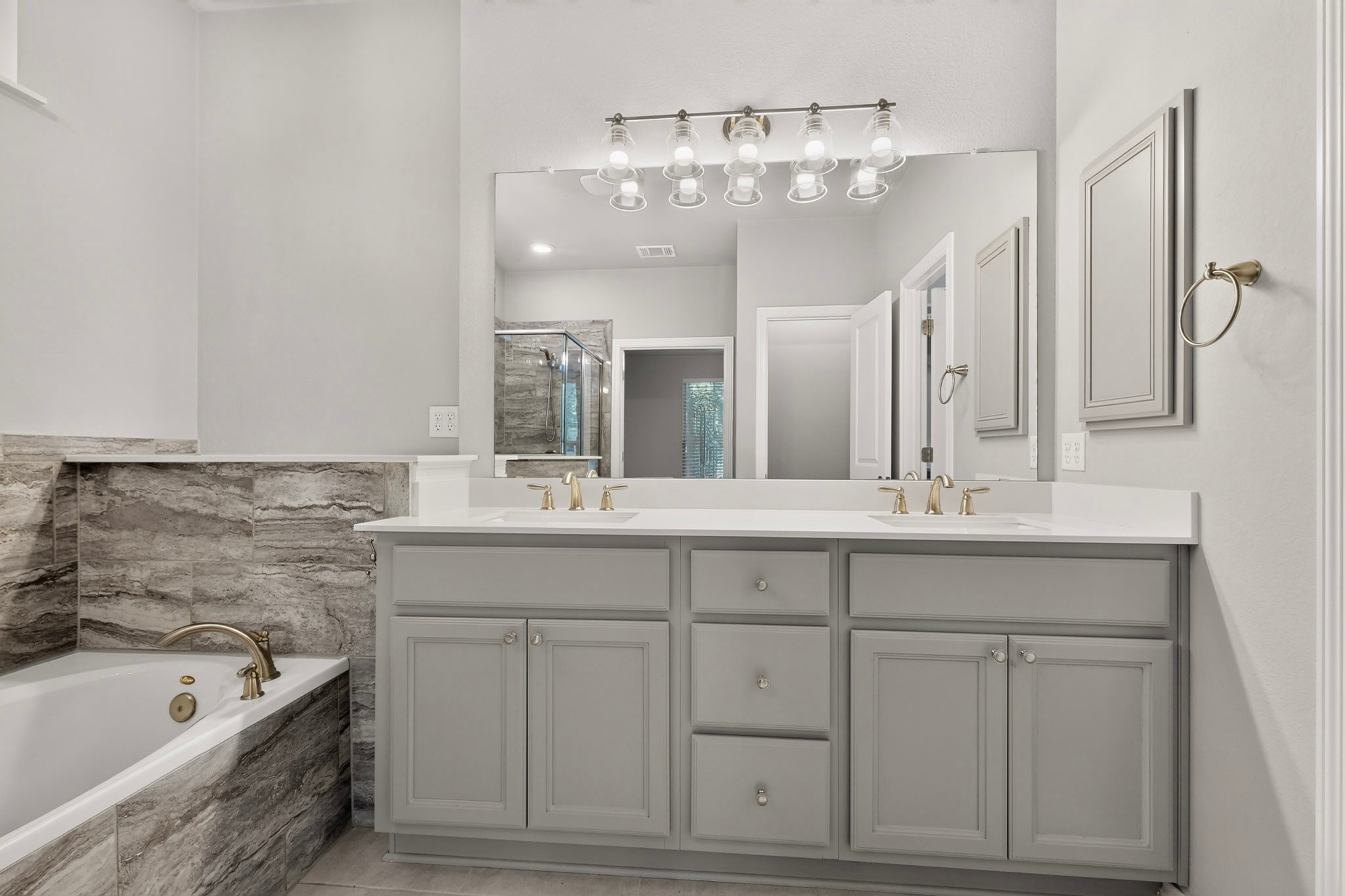 1908 Turtle Bay Loop Leander, TX 78641 - Photo 19 of 38 A refined bathroom featuring a spacious dual vanity, separate tub, and a glass-enclosed shower.