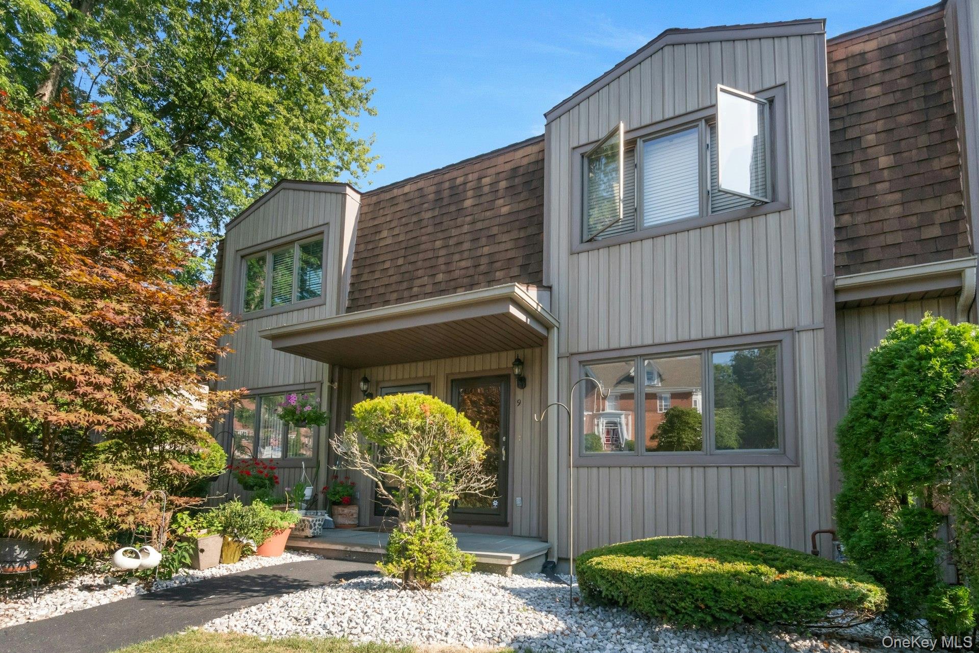 a front view of a house with garden