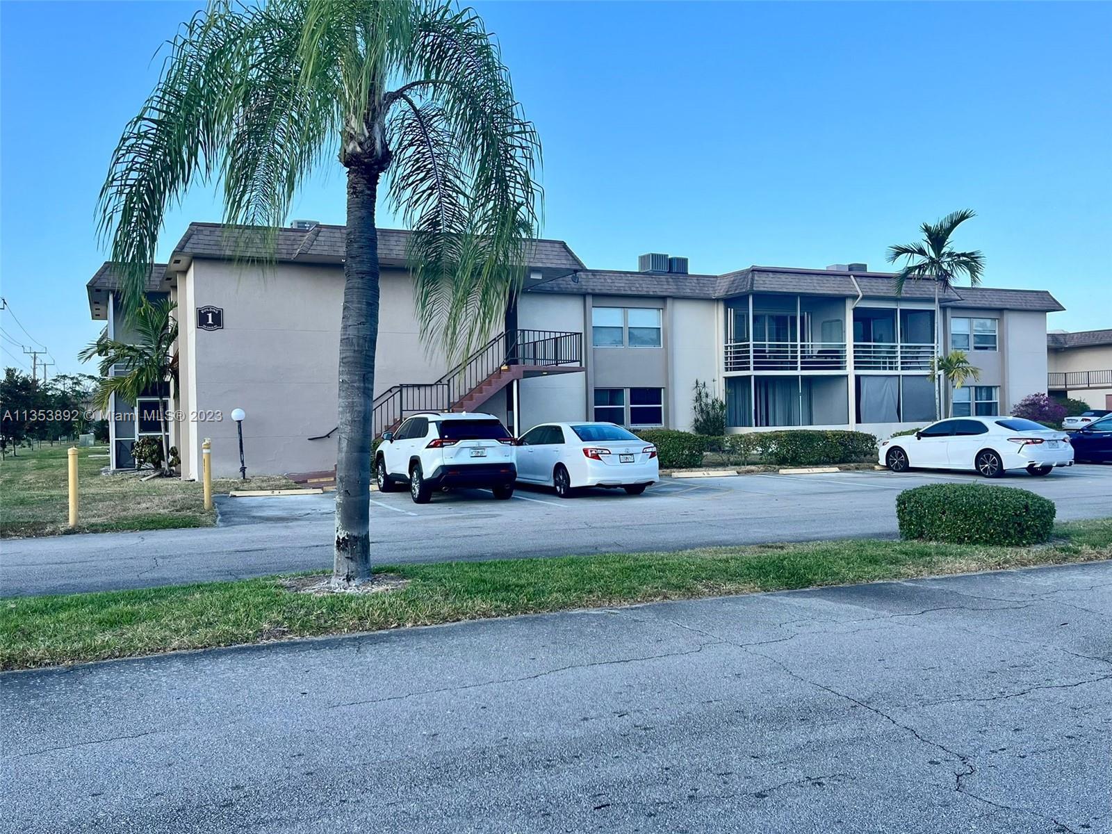 500 Davis Road, Unit 30 Palm Springs, FL 33461 - Photo 1 of 15 a front view of a house with a yard and garage