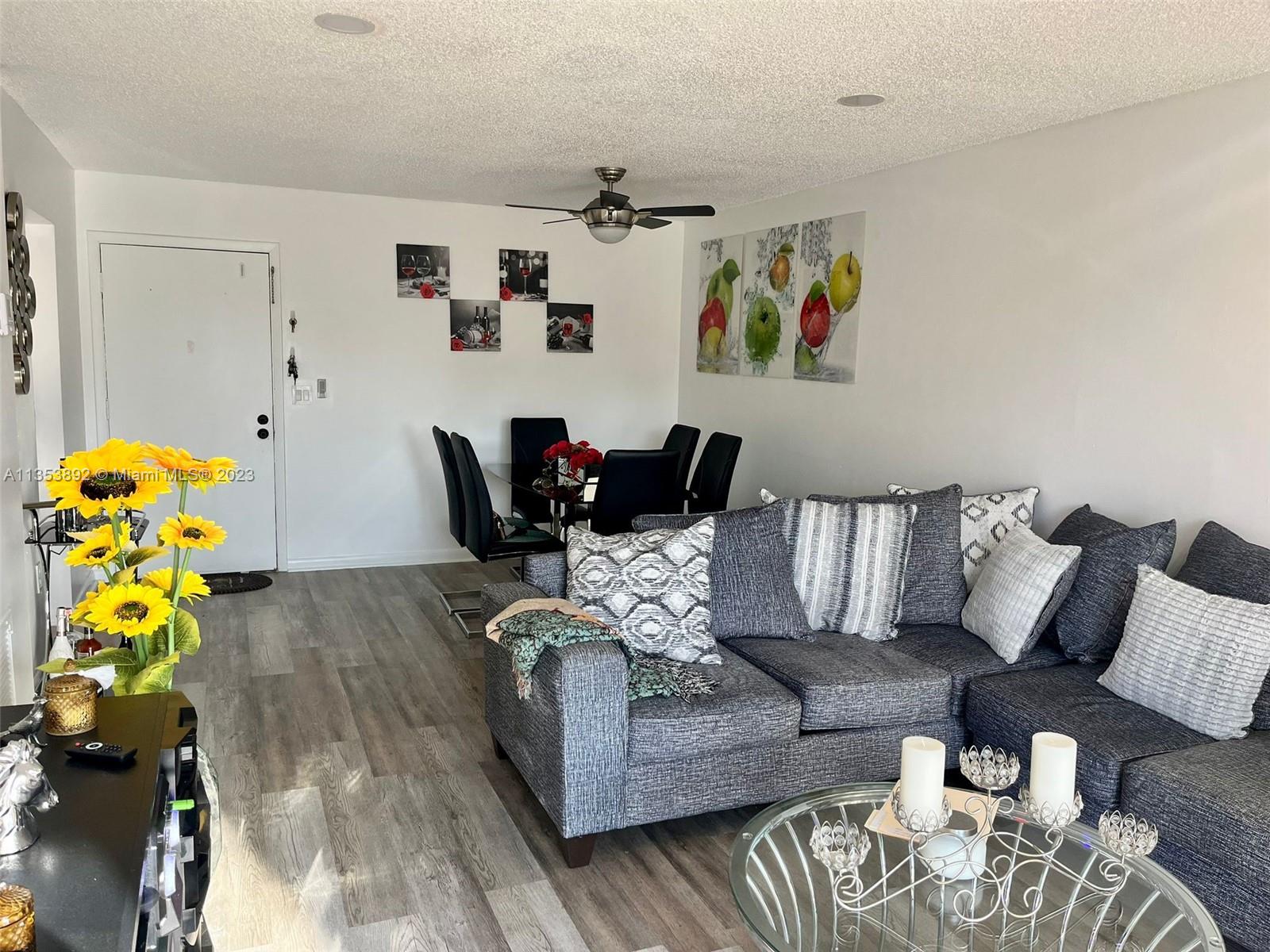 500 Davis Road, Unit 30 Palm Springs, FL 33461 - Photo 3 of 15 a living room with furniture and wooden floor