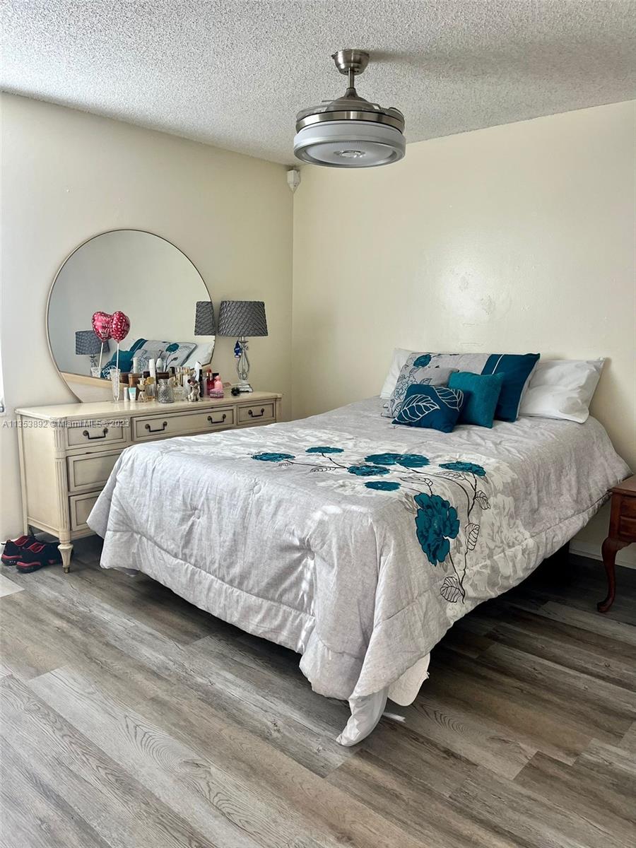 500 Davis Road, Unit 30 Palm Springs, FL 33461 - Photo 8 of 15 a bedroom with a bed and a chandelier