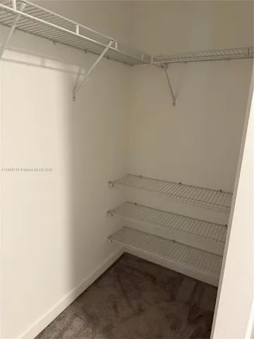 a bed sitting in a room next to a window