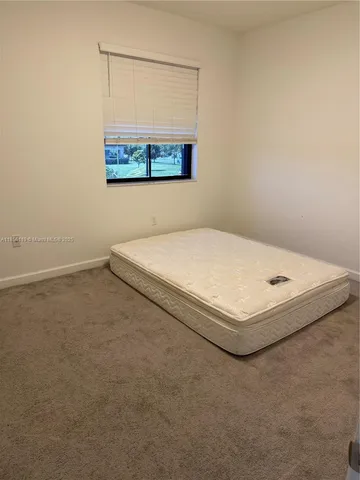 a bedroom with a bed and a lamp