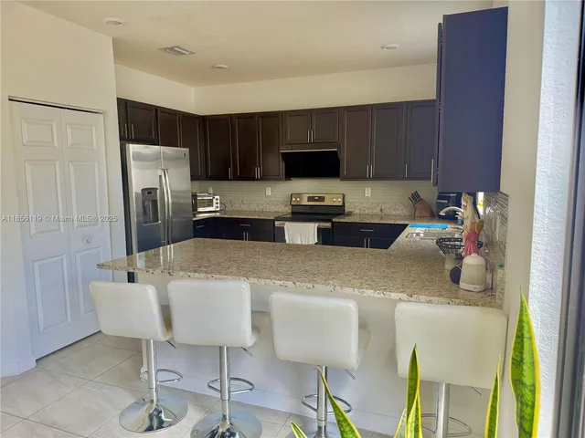 a kitchen with a sink cabinets and refrigerator