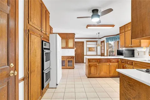 a kitchen with stainless steel appliances granite countertop a sink and a stove