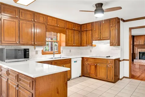 a kitchen with a sink window and cabinets