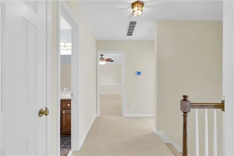 a view of an empty room with a ceiling fan and a window
