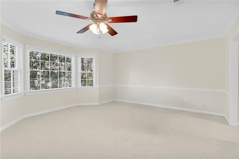 a view of a hallway with a door and wooden floor