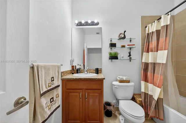 a bathroom with a toilet a sink and a mirror